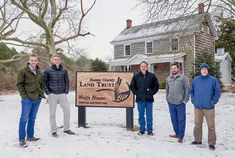 Schell Brothers CEO Chris Schell is joined by Sussex County Land Trust members as he announces his company’s commitment to support the trust financially. Shown are (l-r) SCLT Chair Casey Kenton; Schell; and trustees Sussex County Councilman Mark Schaeffer, Jason King, and Ron Vickers. In the background is the renovated 1880s Wolfe House, which serves as the land trust headquarters near the Junction & Breakwater Trail between Rehoboth Beach and Lewes. SUBMITTED PHOTO